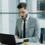 A high net man in front of his laptop doing his business routine
