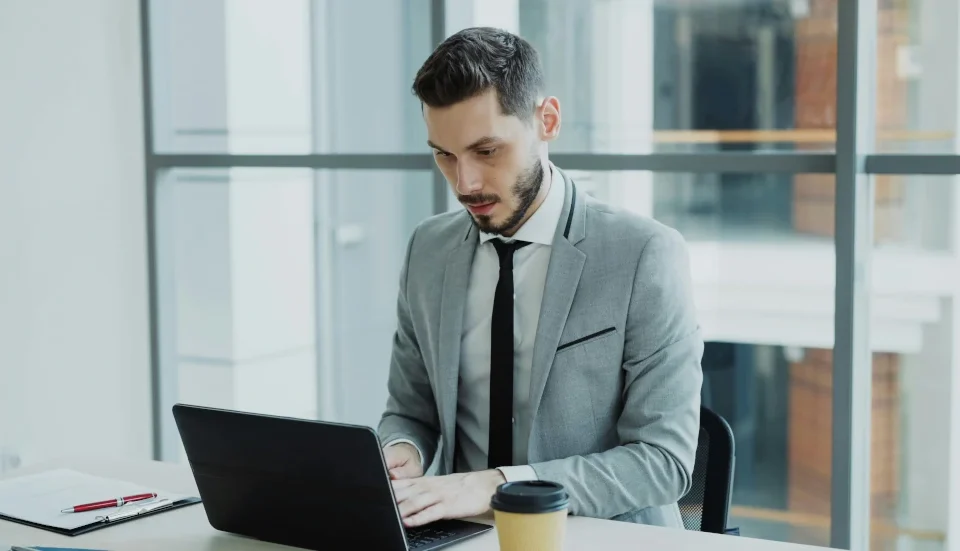 A high net man in front of his laptop doing his business routine